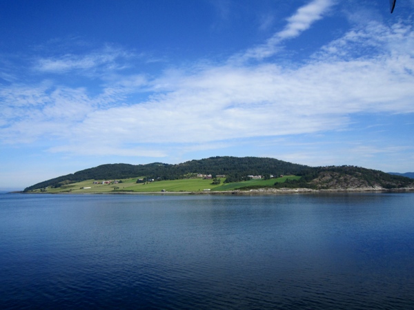 Cruising out of the Trondheimfjord, past some farmland.